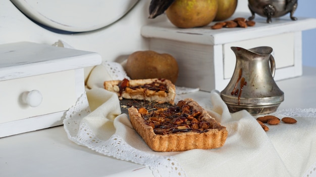 Caramel apple tart on the white wooden buffet