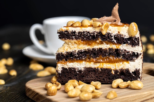 Caramel cake with peanuts and buttercream close up