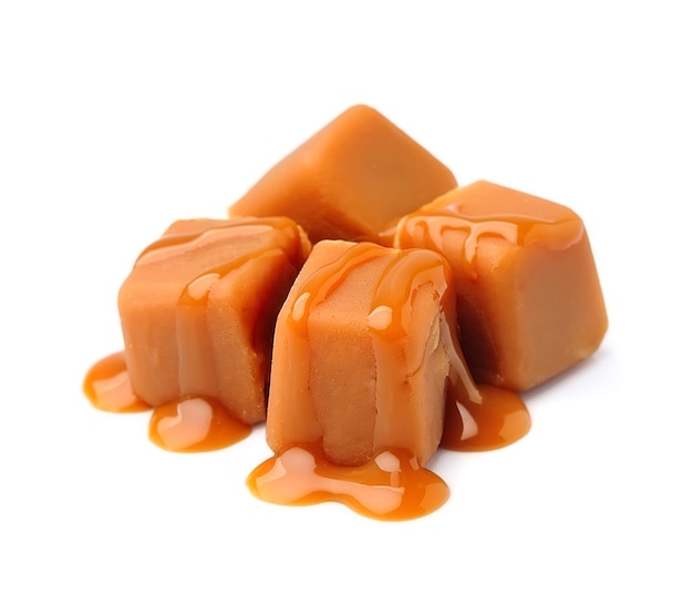 Photo caramel candies and caramel topping isolated.