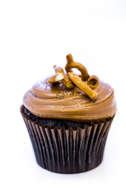 Caramel crunch chocolade cupcake met caramel frosting gegarneerd met zeezout en pretzels.