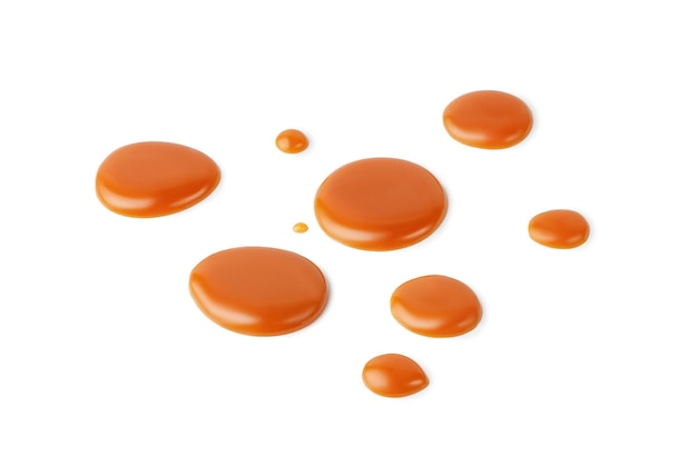 Caramel drops of sweet caramel sauce isolated on white background Melted liquid toffee Top view