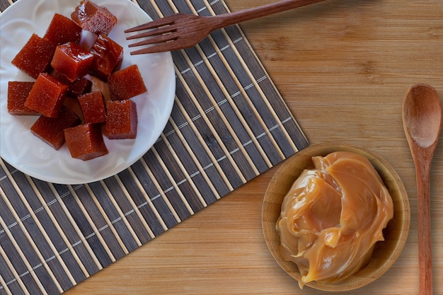 Caramel and guava candy on wooden table  Brazilian desserts