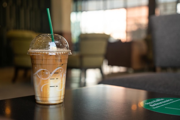 caramel macchiato coffee cup on table in coffee shop