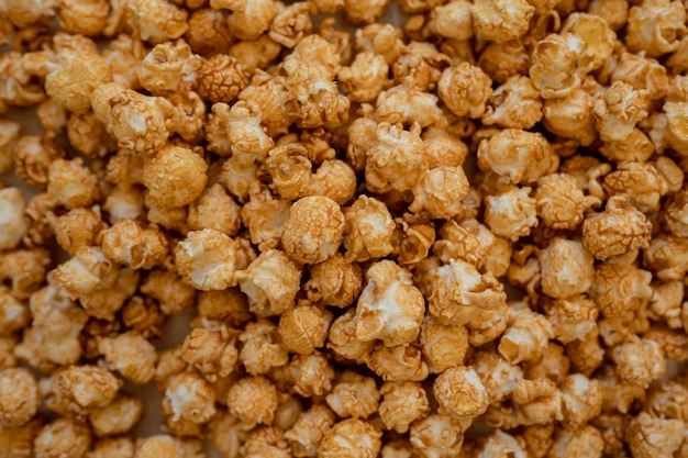 Caramel popcorn background, top view