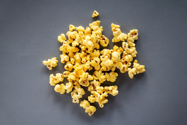 Caramel popcorn on grey background