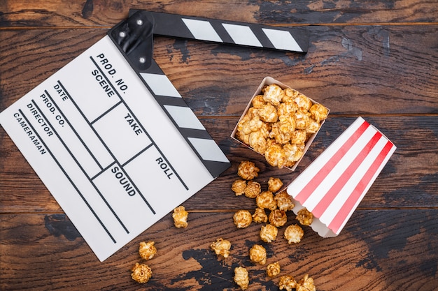 Caramel popcorn and wooden clapper