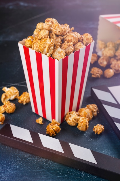 Caramel popcorn and wooden clapper