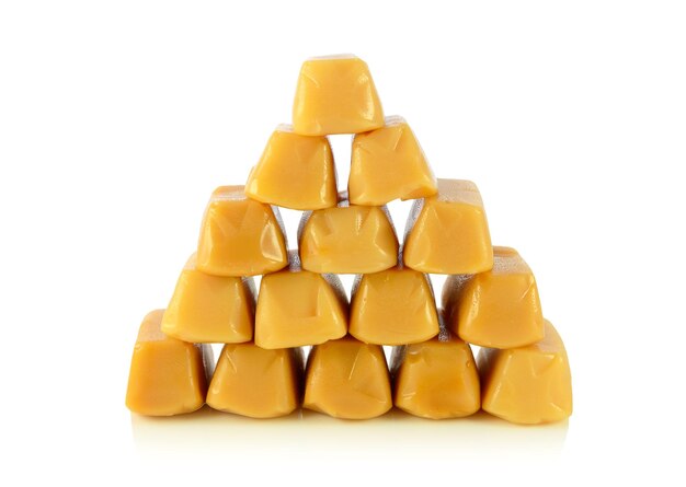 Caramel toffee piled pyramid. Design element isolated on white background