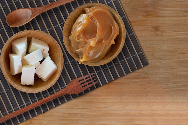 Caramel and white cheese on wooden table  Brazilian desserts