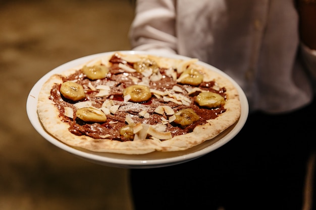 Caramelized Banana Nutella Pizza. Ingredients are Pizza Dough