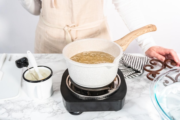 Caramelizing sugar in saucepan to make homemade lollipops