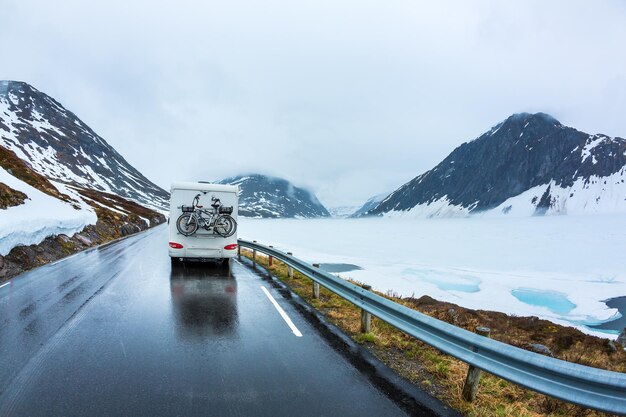 Caravan car travels on the highway. Beautiful Nature Norway natural landscape.