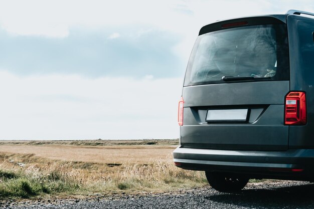 Caravan van with copy space parked on the wild lands during a road trip on icelandVanlife live in a beautiful bus in the open natureTravel epic road trip through mountains Nomadic lifestyle