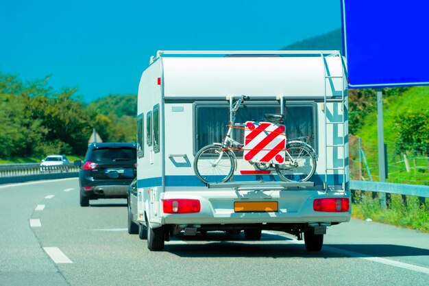 Caravan with bicycle on the highway in Switzerland.