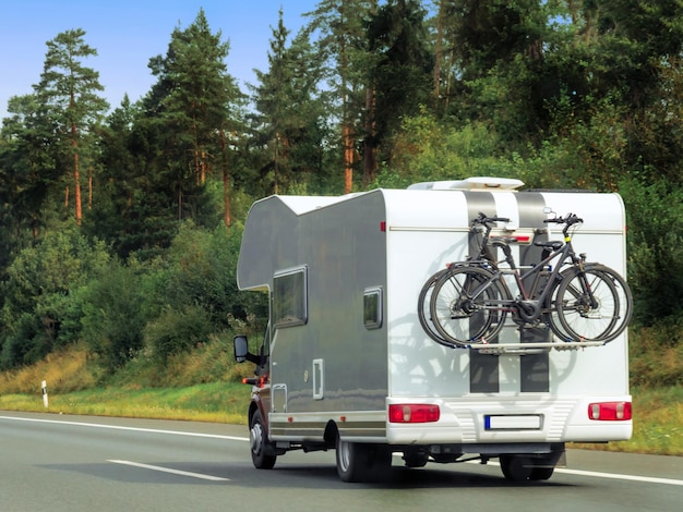 Photo caravan with bicycles on the highway in switzerland.