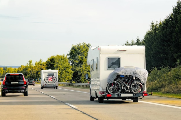 Caravans with bicycles on the road at Switzerland.