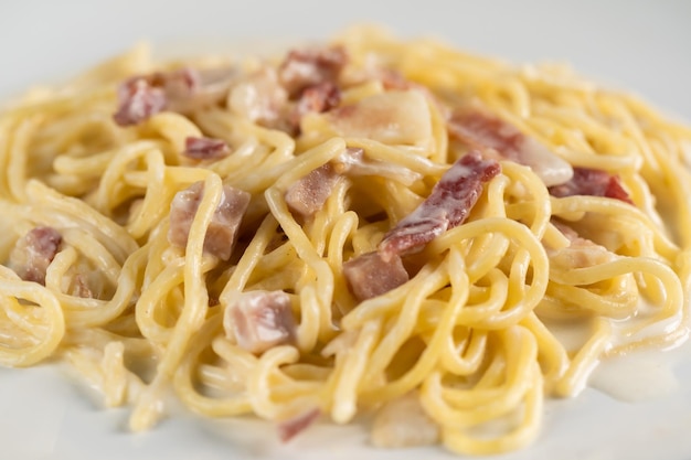 Carbonara spaghetti with cream on white plate