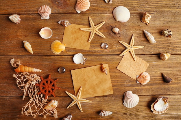 Photo card blanks with sea stars and shells on wooden background