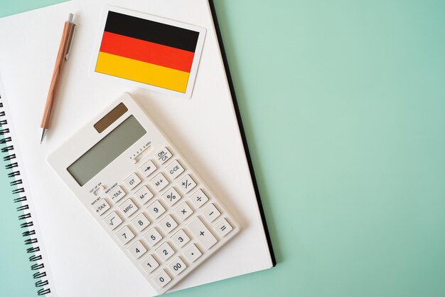 Photo the card of the flag of germany calculator pen and notebook