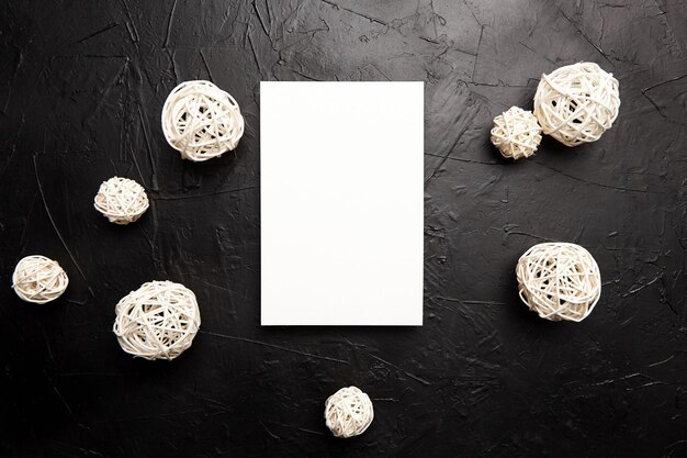 Card mockup blank wedding invitation with white white balls decor on black table