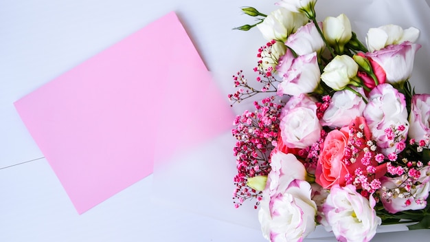 Card mockup with delicate bouquet. floral background. Top view Flat lay Holiday card 8 March, Happy Valentine's day, Mother's day concept. Copy space for text. Holiday greeting card