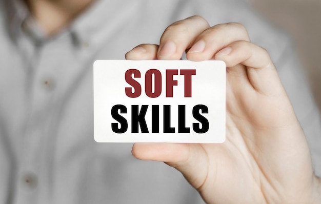 Card with text Soft Skills in a man's hand