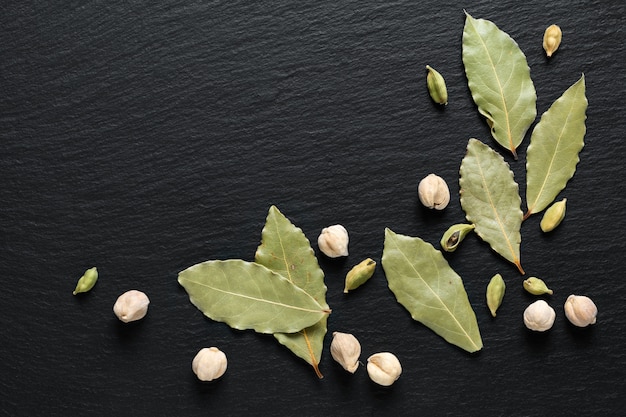 cardamom pods on black slate stone with copy space