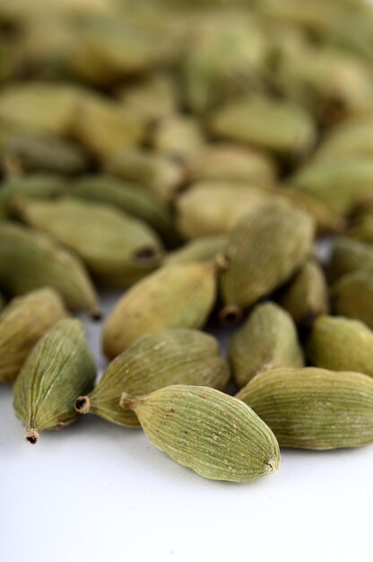 Cardamom pods on white background