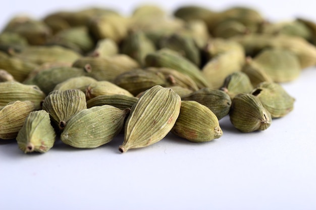 Cardamom pods on white