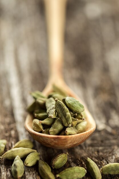 Cardamom seasoning in a wooden spoon close up