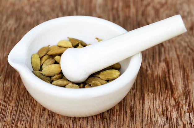 Cardamom seeds in a mortar with pestle