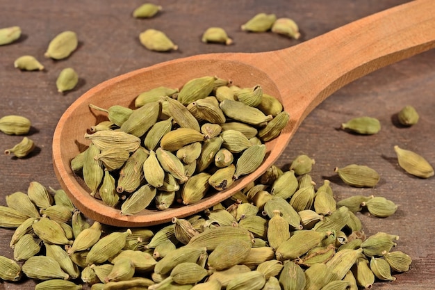 Cardamom seeds wooden spoon