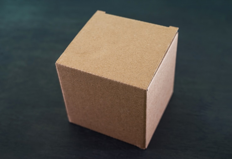 Cardboard box on a black wooden table.