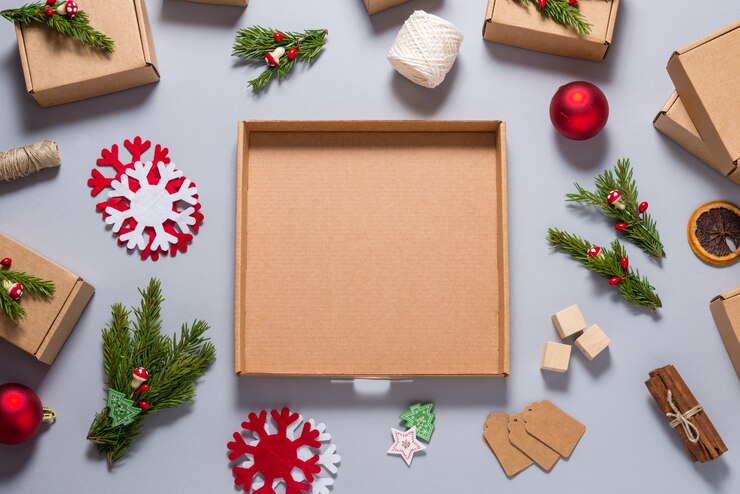 Photo cardboard box decorated with christmas tree ornament on grey background