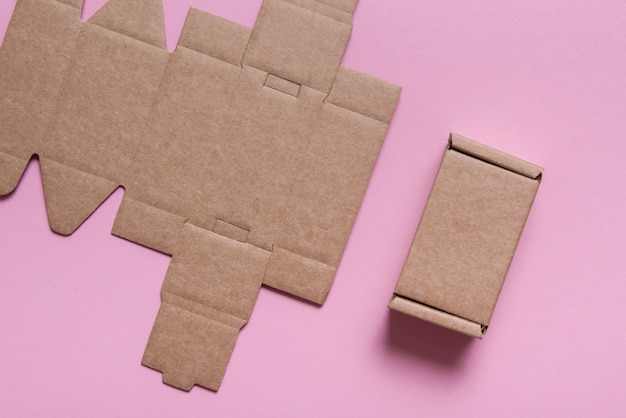 Cardboard box, flat packed,pink background