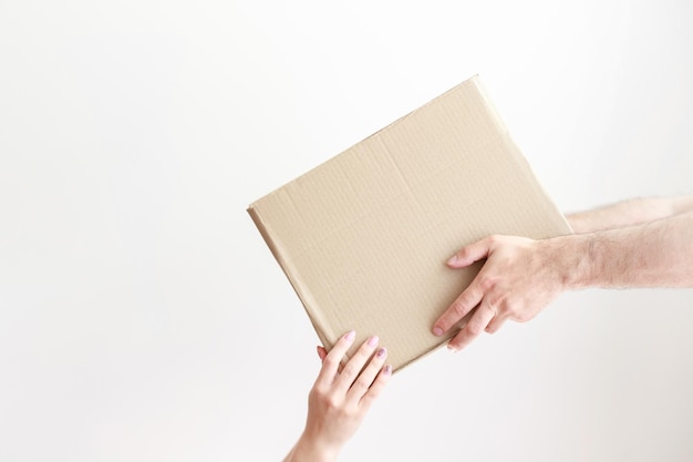 Photo cardboard box in hand give a box with delivery