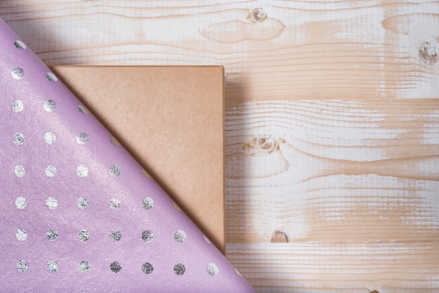 Cardboard box and lilac polka dot wrapping paper. 