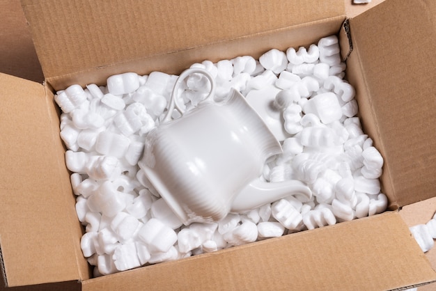 Cardboard box on loose white Filler Shipping Packing Peanuts