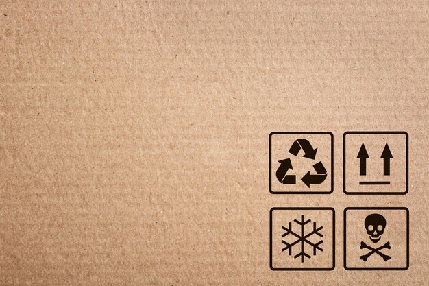 Photo cardboard box with packaging symbols as background closeup