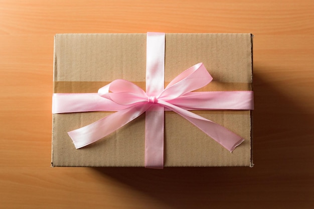 Cardboard box with a pink ribbon Gift