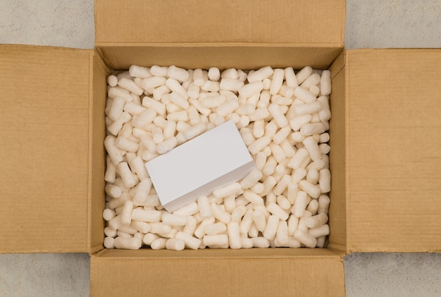 Cardboard box with styrofoam filler for safe packaging. Gift package. Top view