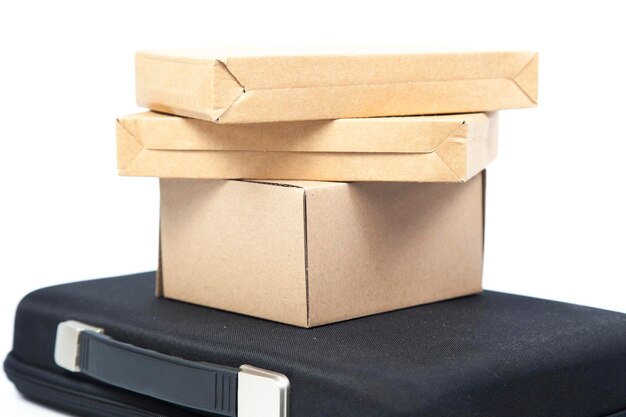 Photo cardboard boxes on suitcase against white background