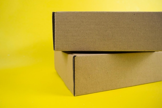 cardboard boxes of various shapes and positions isolated on a yellow background