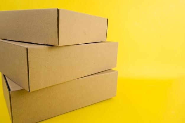 cardboard boxes of various shapes and positions isolated on a yellow background