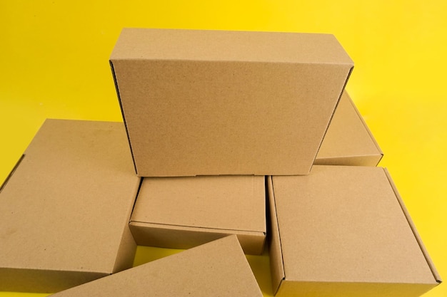 Cardboard boxes of various shapes and positions isolated on a yellow background