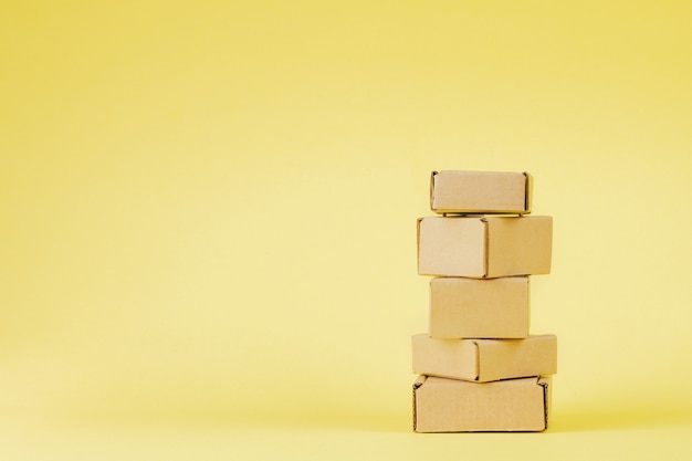 Cardboard boxes of various sizes on yellow background.