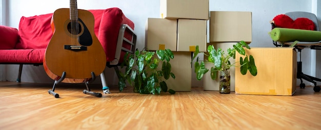 Photo cardboard boxes with personal belongings in living room at moving relocation day no people