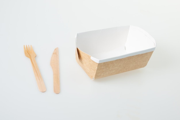 Cardboard brown carton box food to take away from snack fast food with wooden fork and knife