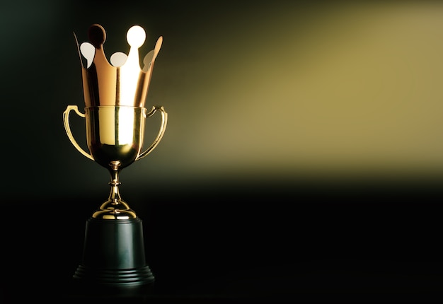 Cardboard golden crown on top of the champion golden trophy.