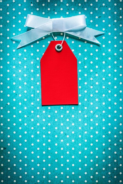 Cardboard sale tag on blue polkadot table cloth